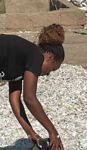 Worker safely handling shredded material